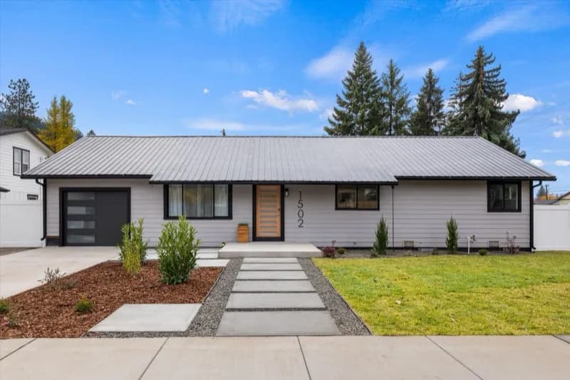 Renovated ranch home with metal roof and modern entry
