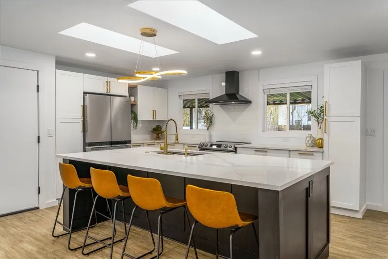 Renovated kitchen with bold orange bar stools