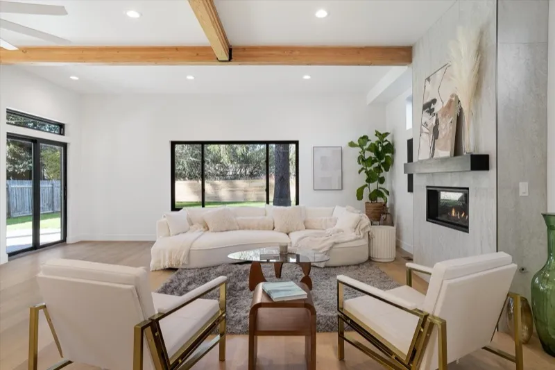 Open living room with curved sofa and gas fireplace